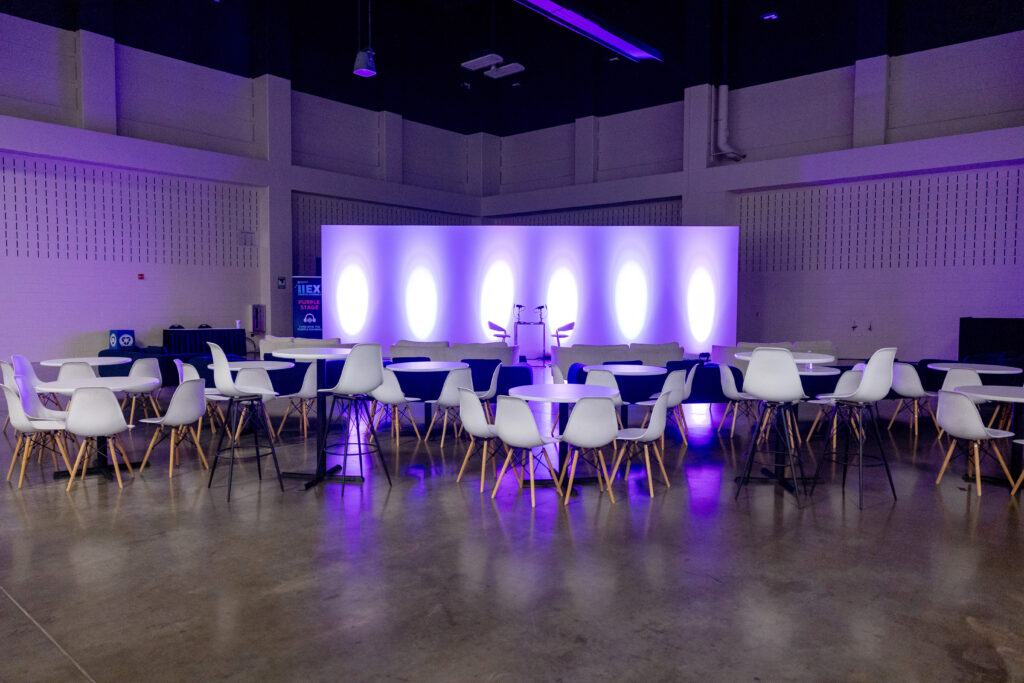 a creative corporate event panel audience setup using modern decor and furniture