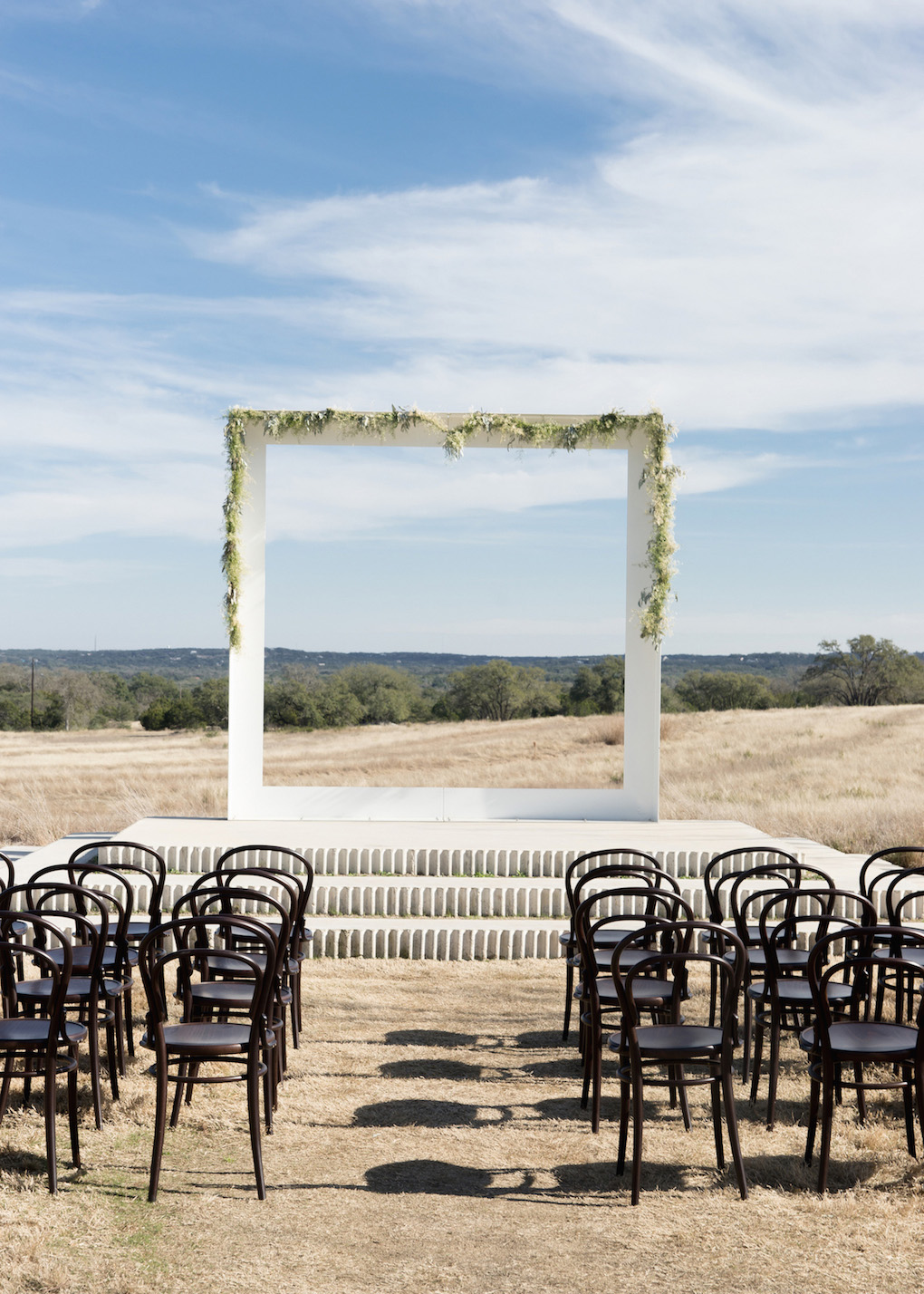 a square wedding backdrop with Texas Hill Country scenery in the background