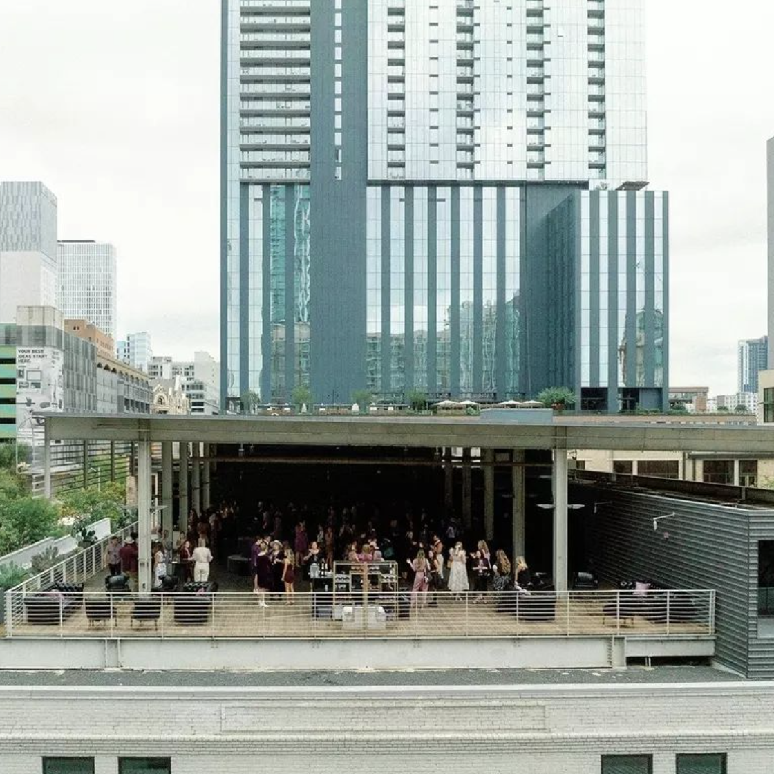 rooftop of Brazos Hall in downtown Austin with a skyscraper in the background