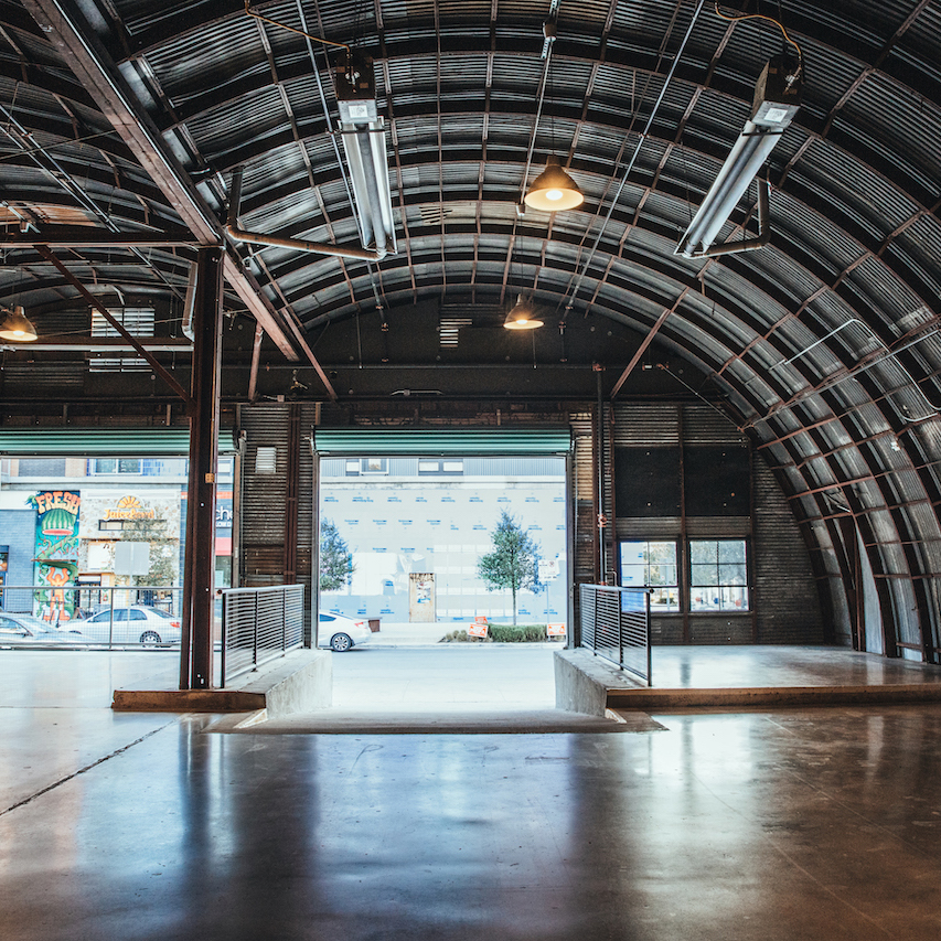 interior of Fair Market in Austin, TX, featuring concrete floors and metal ceiling